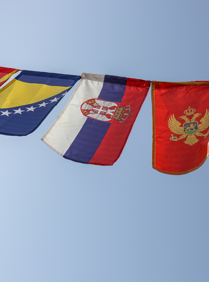 Flags of Balkan Countries And Russia Swaying Together Against The Blue Sky